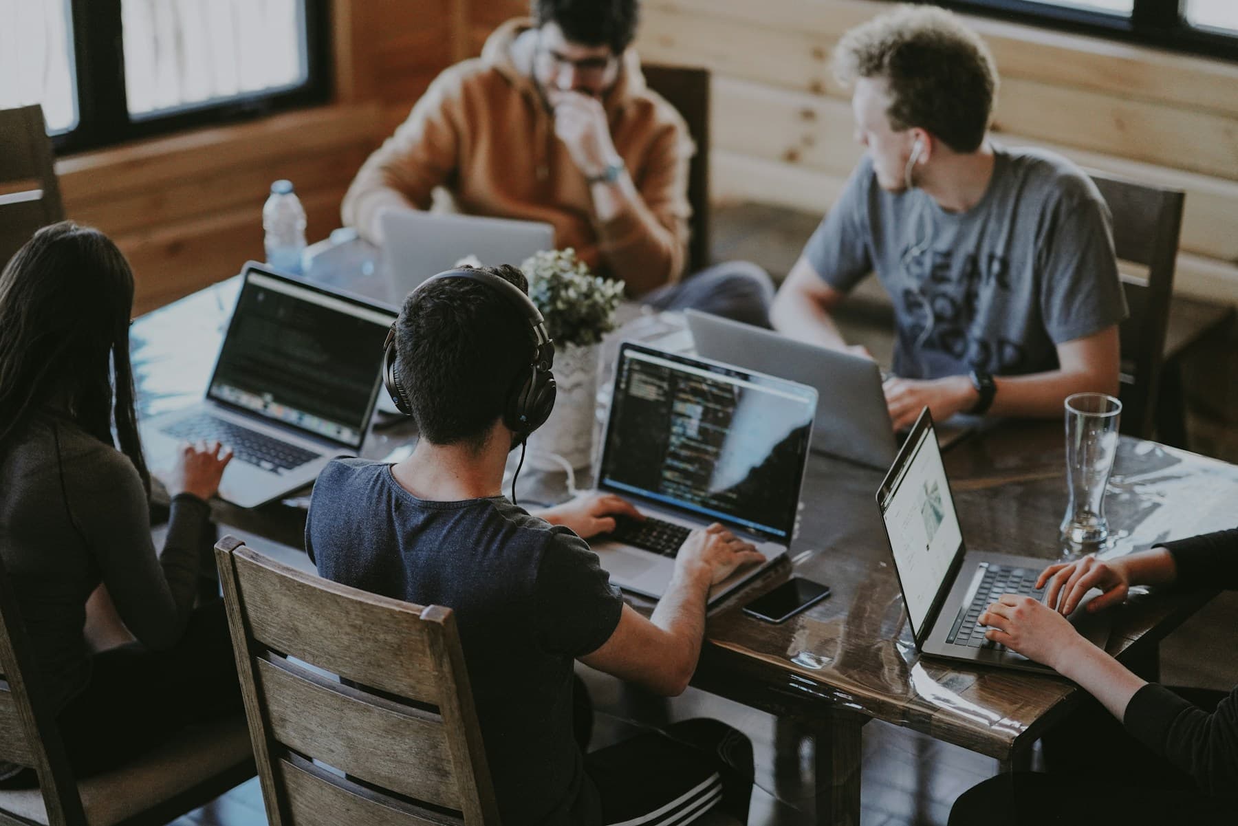 People collaborating around a table in a bright creative workspace
